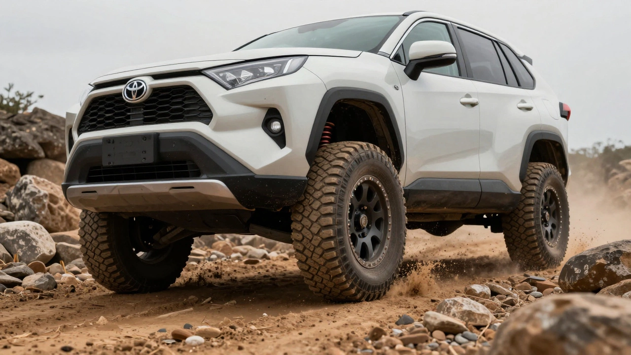 A lifted Toyota RAV4 on a rocky dirt track with all-terrain tires gripping uneven ground.